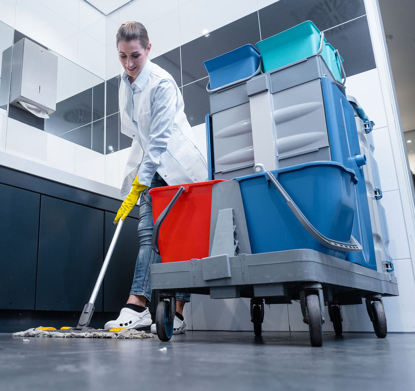 Maintenance worker using mop